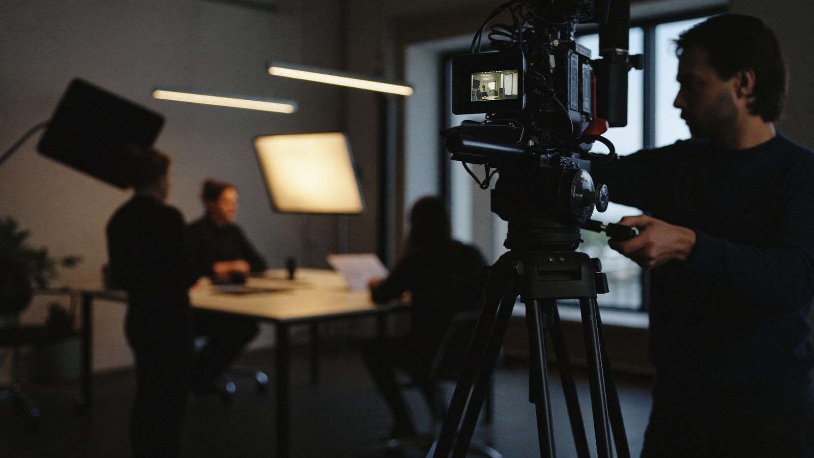A professional film crew shooting a corporate film with cinema camera and reference monitor
